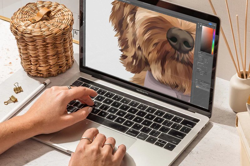Digital illustration of a dog being hand-drawn on a laptop